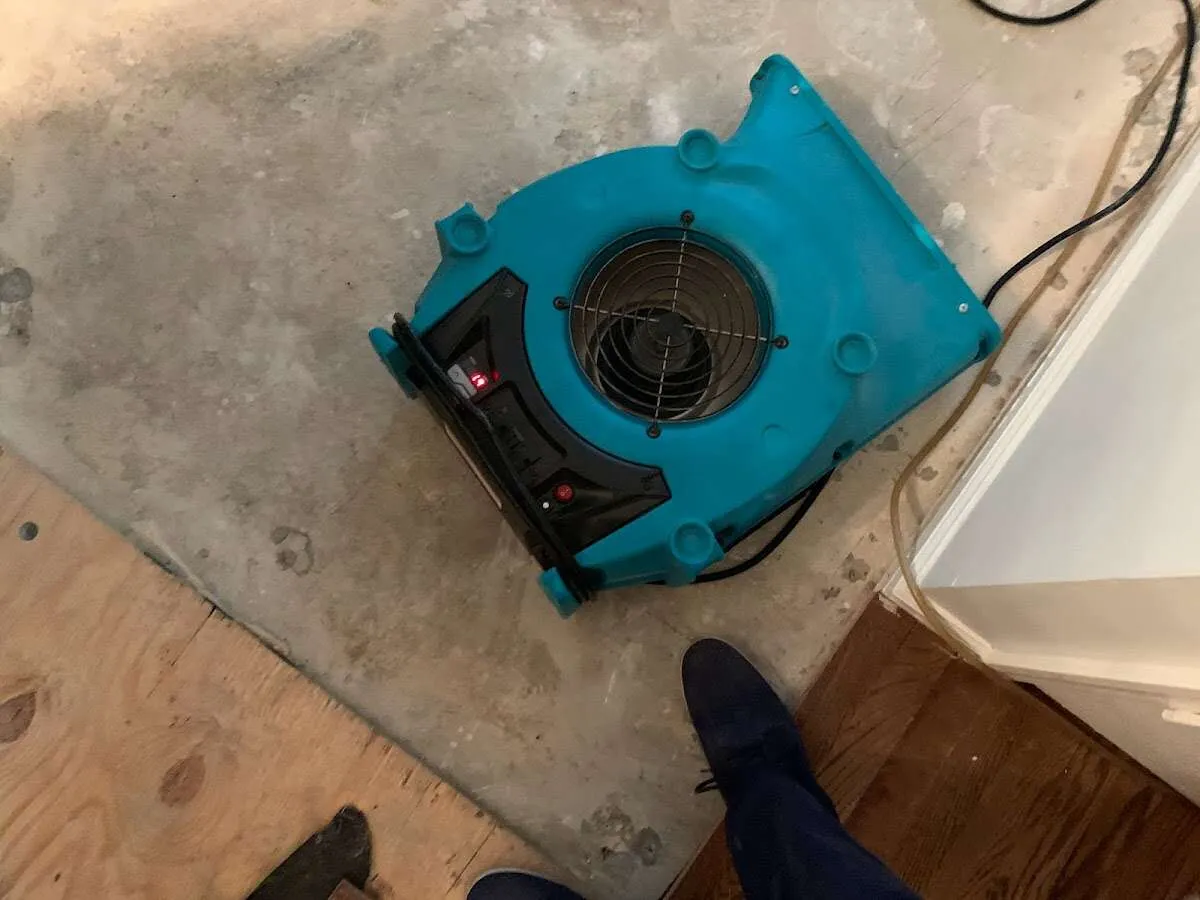 Air mover drying subfloor during Leak Detection & Repair in Sheboygan